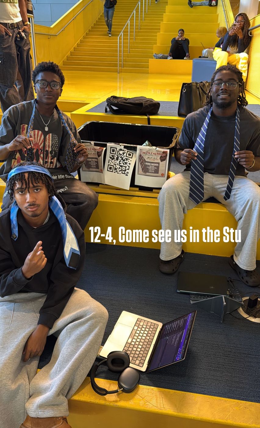Miles and friends running The Tie Exchange donation table in the student union